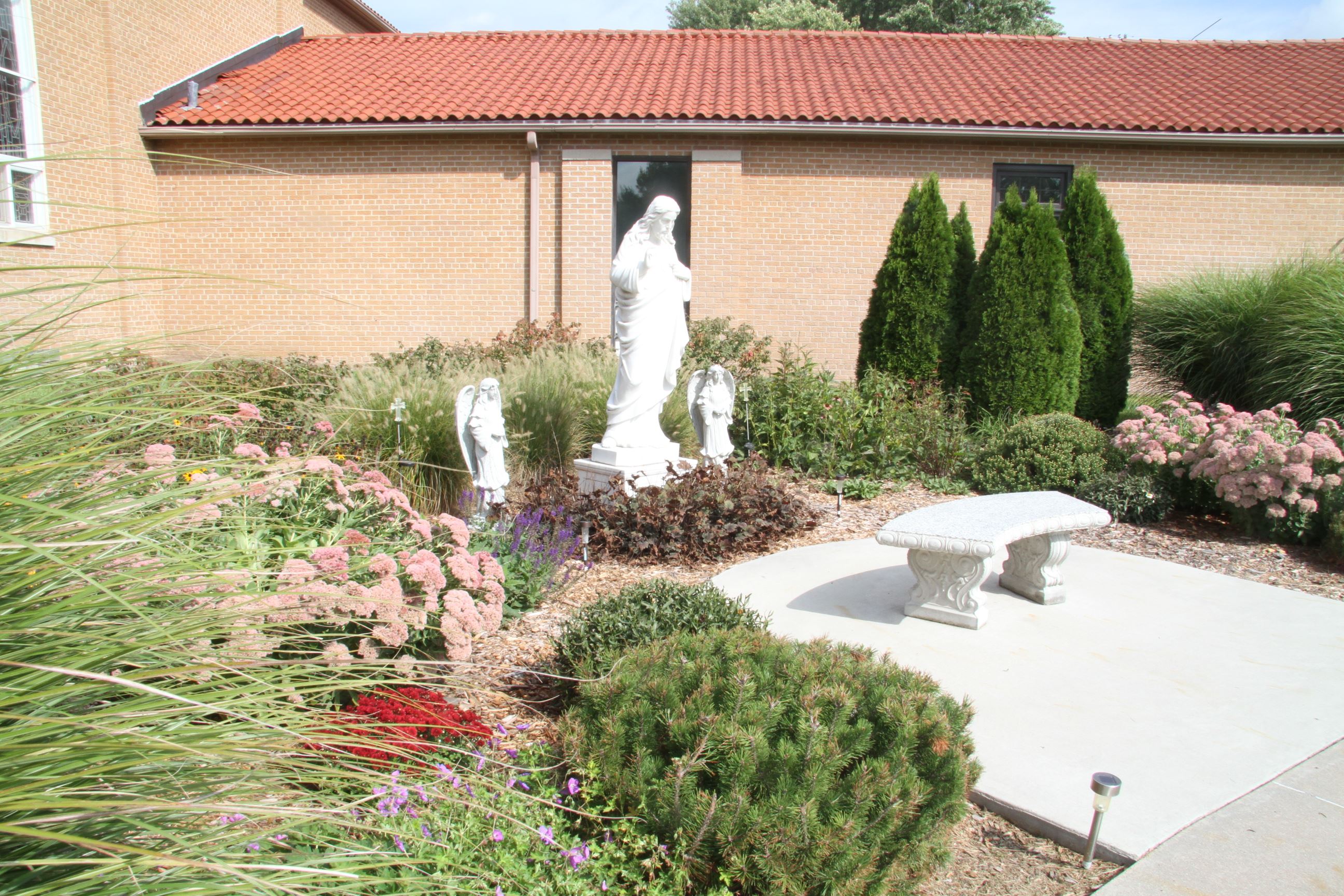 Sacred Heart Church Building with Sculpture on Grounds